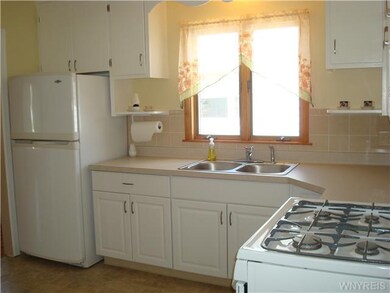Kitchen Updated kitchen features white cabinetry, 