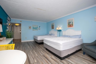 Bedroom with wood finished floors and ornamental m