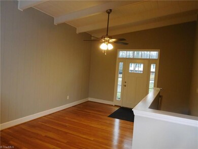 Entrance:  Beautiful new hardwood floors, fresh paint, new light fixtures.  Vaulted beam ceiling makes home feel huge!