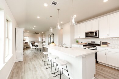 The kitchen is a culinary haven, featuring quartz