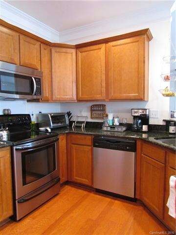 Kitchen features granite countertops, smooth top s