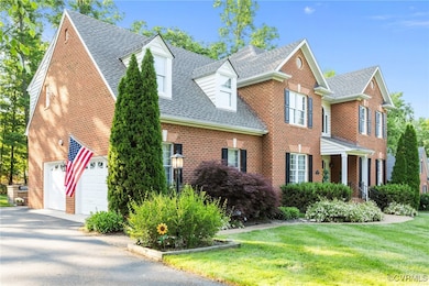 View of front facade with a shingled roof, brick s