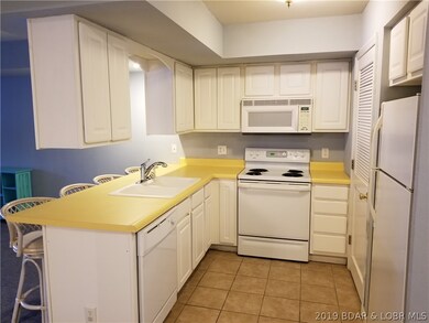 Kitchen with Breakfast Bar and Utility Closet.
