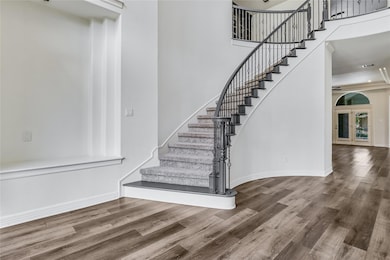 Staircase featuring baseboards, french doors, and