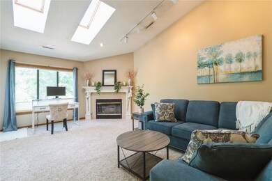 Living Room with Vaulted Ceiling and Skylights