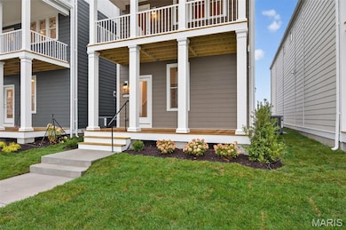 Entrance to property with a lawn