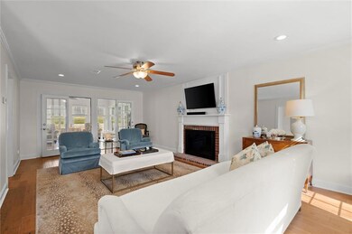 Living room featuring a fireplace, wood finished f