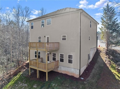 Rear view of property with a balcony and a deck