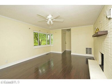 Living Room. Lots of room in this space. Great corner window overlooks built-in flower box outside window.  New lighting and paint throughout.