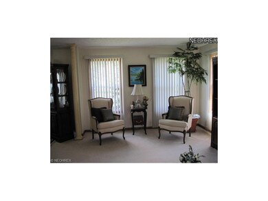 The formal living room is accented by wooden floor