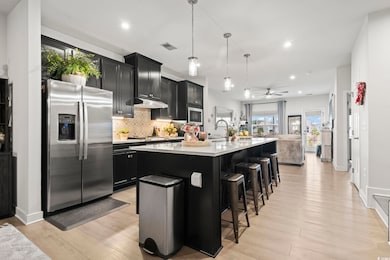 Kitchen with a kitchen bar, hanging light fixtures
