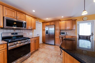 Kitchen featuring appliances with stainless steel finishes, dark stone counters, tasteful backsplash, and recessed lighting