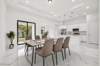 Dining room with a tray ceiling, recessed lighting