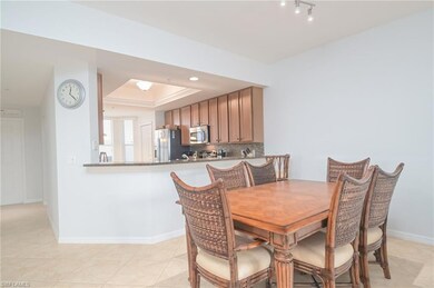 Tiled dining space featuring a tray ceiling and ra