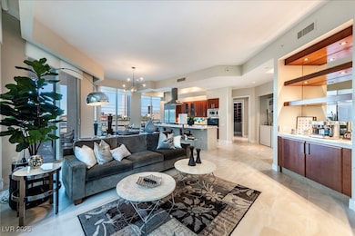Living room featuring a chandelier and light marbl