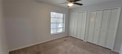 Unfurnished bedroom with carpet, multiple closets, baseboards, and ceiling fan
