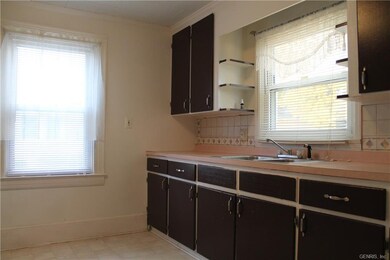 A spacious kitchen overlooks the backyard.