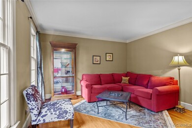Living room with crown molding and hardwood / wood-style floors