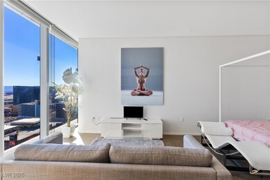Living area with baseboards and expansive windows