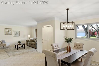 Dining space with light carpet, a chandelier, and arched walkways