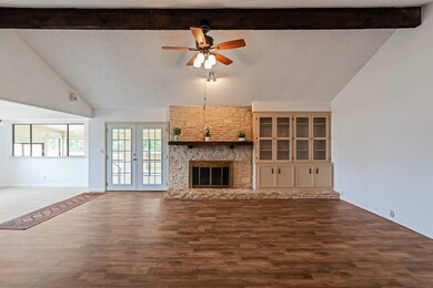 Unfurnished living room with dark wood-style floo