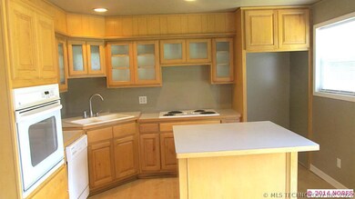 island kitchen, with stove top, built in oven.