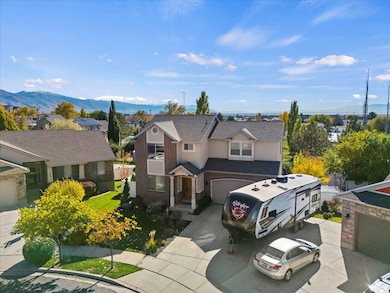 View of front facade featuring a residential view, a garage, stucco siding, and concrete driveway