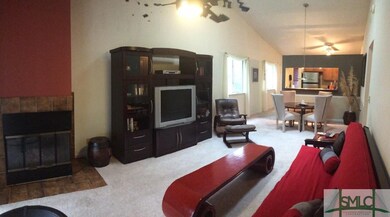 The Den with a custom tiled fireplace and open vie
