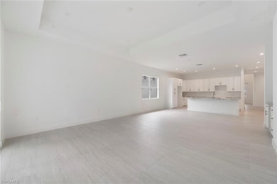 Unfurnished living room with baseboards and recessed lighting