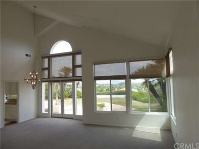 Living room and dining room feature high ceilings,