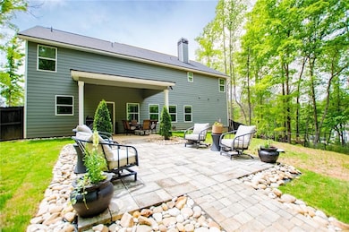 Back of property with a fenced backyard, a patio, 