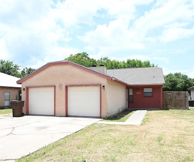 Single story home with an attached garage, a chim