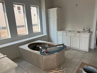 Bathroom with tile patterned floors and a garden 