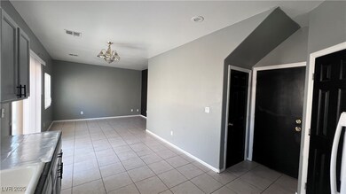 Unfurnished living room featuring a chandelier, li