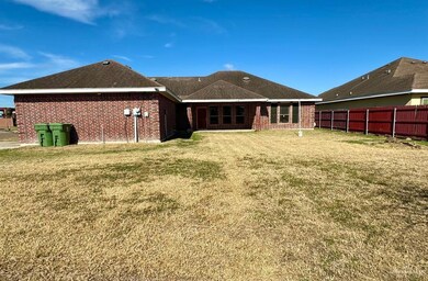 Rear view of property with a lawn