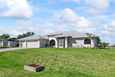 Ranch-style home featuring a front yard and a gara