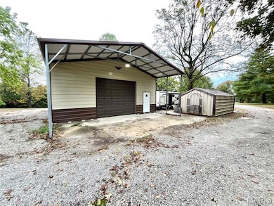 Detached garage with a storage shed and driveway