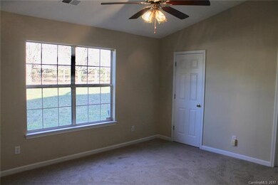 Master bedroom has vaulted ceilings and views of t