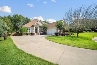 View of front facade featuring driveway, a garage, and stucco siding