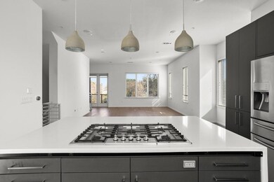 Kitchen featuring stainless steel appliances, ope