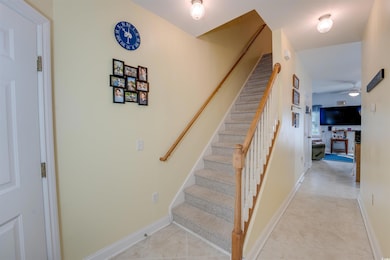 Staircase with ceiling fan and baseboards