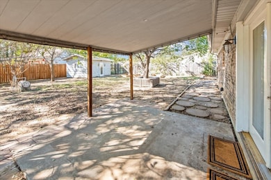 Fenced backyard with a patio and a shed