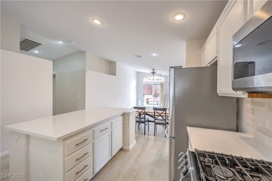 Kitchen featuring stainless steel appliances, ligh
