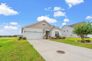 View of front of house with a garage and a front y