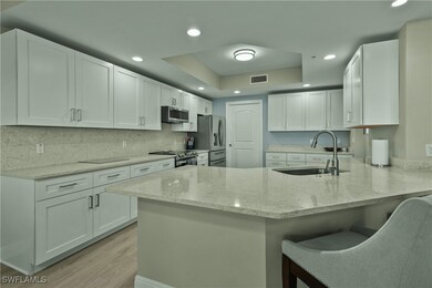 Kitchen with kitchen peninsula, sink, appliances w