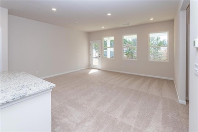 Empty room with light carpet, baseboards, and recessed lighting