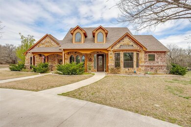 Warm and inviting front elevation with a combo of brick and stone.