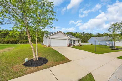 View of front facade featuring a garage, board and