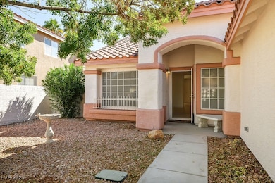 Entrance to property featuring a tile roof and stucco siding