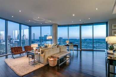 Living room with a wall of windows and dark wood-t